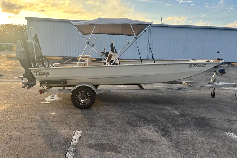 Slide: The Image of 2015 Express XP20CC boat on trailer, parked outdoors at sunset. - 10