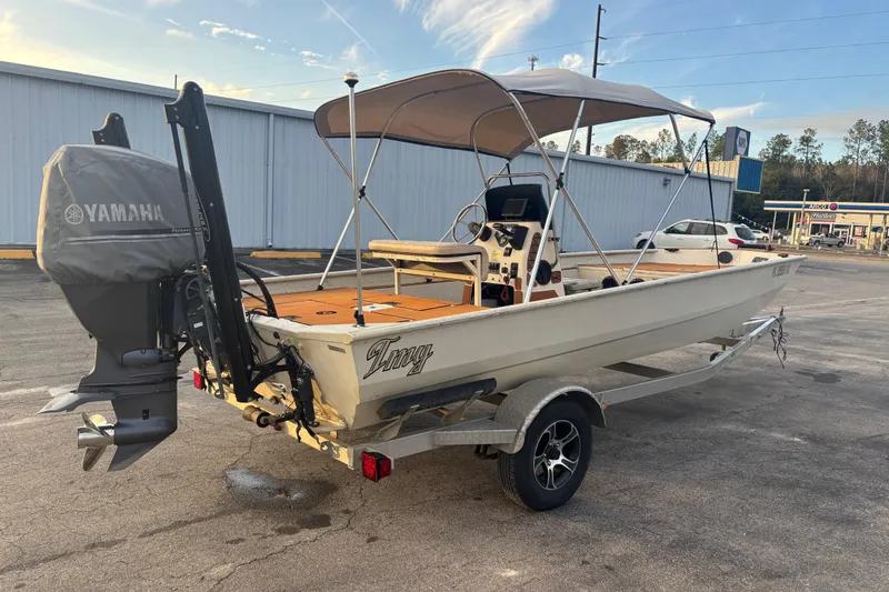 Slide: The Image of 2015 Express XP20CC boat with Yamaha motor on trailer in parking lot. - 11