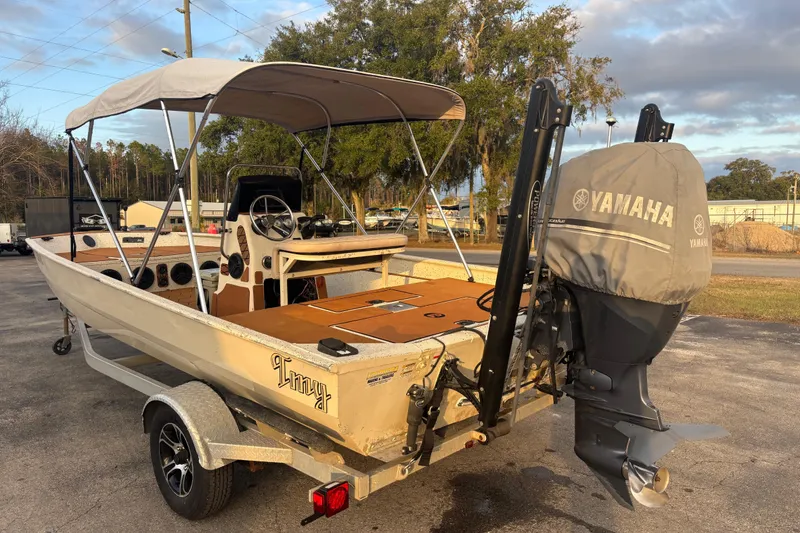 Slide: The Image of 2015 Express XP20CC boat with Yamaha outboard motor, parked on a trailer. - 12