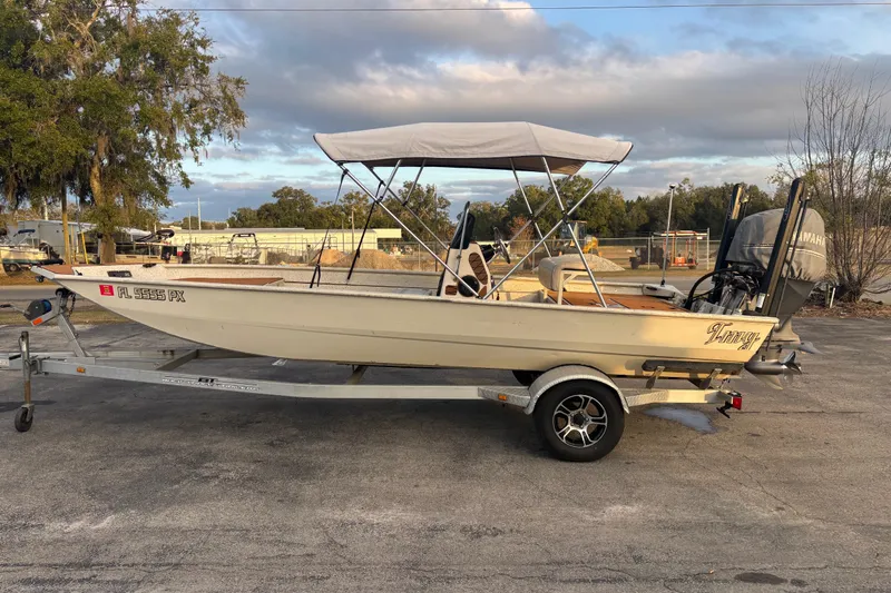Slide: The Image of 2015 Express XP20CC boat on trailer with canopy, parked outdoors. - 13