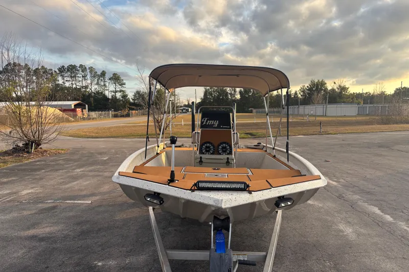 Slide: The Image of 2015 Express XP20CC boat on trailer under cloudy sky, parked on asphalt. - 15