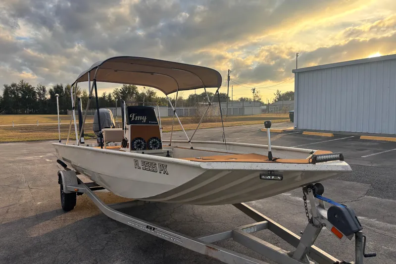 Slide: The Image of 2015 Express XP20CC boat on trailer at sunset, parked near a building. - 18