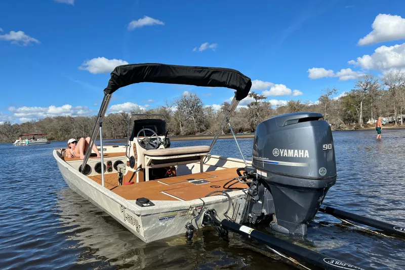 Slide: The Image of 2015 Express XP20CC boat with Yamaha motor on a sunny day by the water. - 3