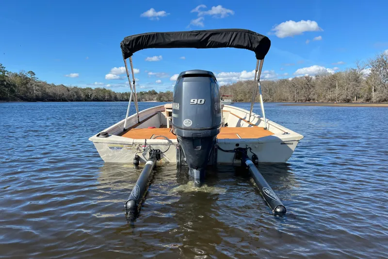 Slide: The Image of 2015 Express XP20CC boat with Yamaha 90 engine on a calm river. - 4