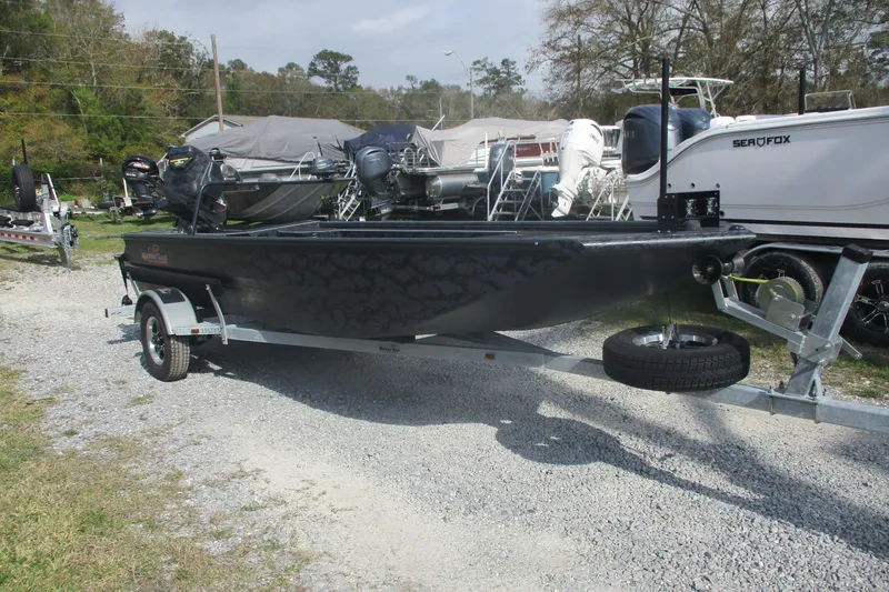 Slide: The Image of 2026 Gator Tail 1854 Extreme boat on trailer, parked outdoors. - 2