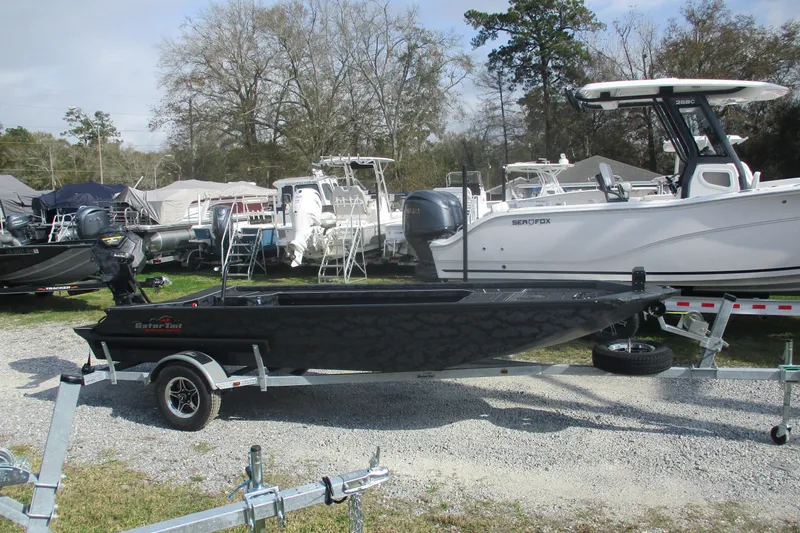 Slide: The Image of 2026 Gator Tail 1854 Extreme boat on trailer, surrounded by other boats in a lot. - 3