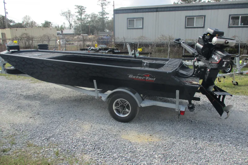 Slide: The Image of 2026 Gator Tail 1854 Extreme boat on trailer, parked outdoors. - 7