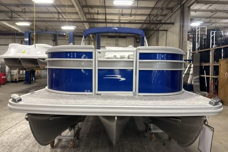 Slide: The Image of 2026 Bennington 22SXSR pontoon boat in a warehouse, front view. - 3
