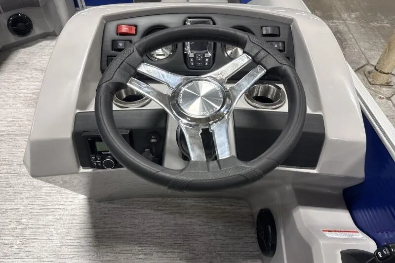 Slide: The Image of Steering console of 2026 Bennington 22SXSR boat with modern controls and cup holders. - 6