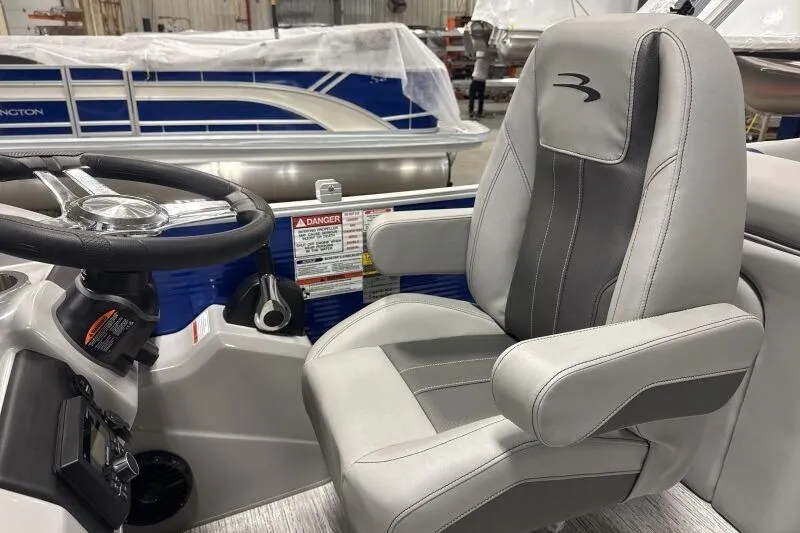 Slide: The Image of 2026 Bennington 22SXSR boat interior with steering wheel and captain's chair. - 7