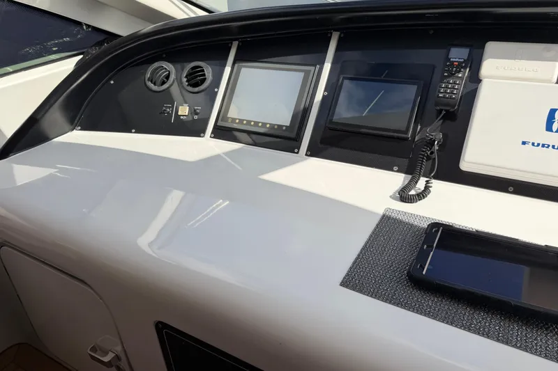 Slide: The Image of Control panel of a 2004 Mangusta 72 yacht with navigation screens and communication devices. - 10
