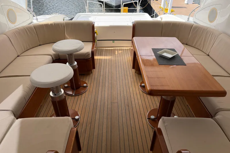 Slide: The Image of Luxurious 2004 Mangusta 72 yacht interior with elegant seating and wooden table. - 11