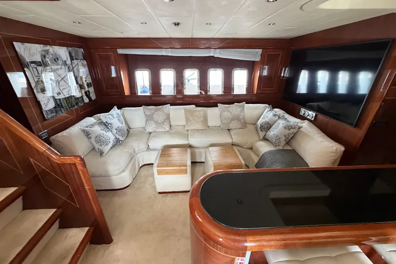 Slide: The Image of Luxurious 2004 Mangusta 72 yacht interior with plush seating and elegant wood finishes. - 17