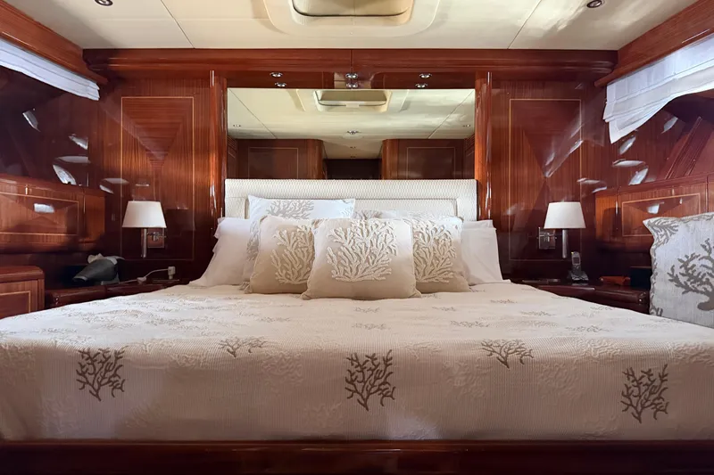 Slide: The Image of Luxurious bedroom interior of 2004 Mangusta 72 yacht with elegant wood paneling and plush bedding. - 21