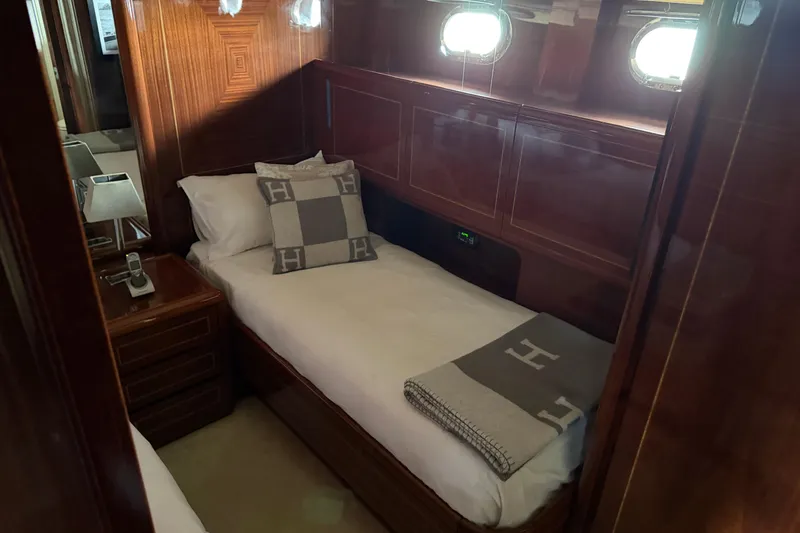 Slide: The Image of Luxurious cabin interior of 2004 Mangusta 72 yacht with elegant wood paneling. - 27