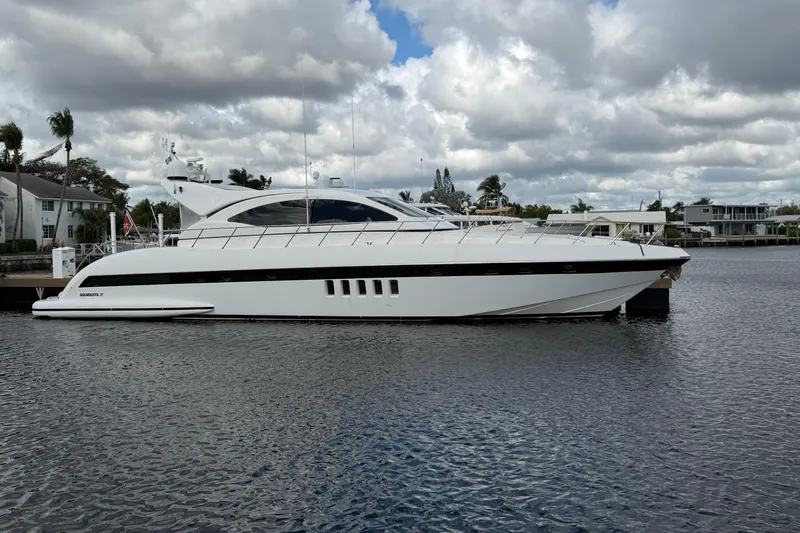 Slide: The Image of Luxury 2004 Mangusta 72 yacht docked on a cloudy day. - 3