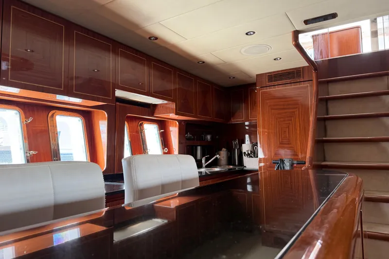 Slide: The Image of Luxurious interior of 2004 Mangusta 72 yacht with polished wood and modern kitchen. - 32