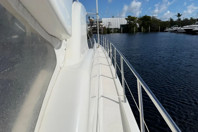 Slide: The Image of Side view of a 2004 Mangusta 72 yacht docked by the water. - 34