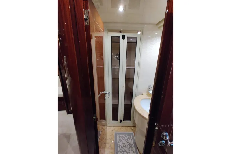 Slide: The Image of Luxurious bathroom interior of 2004 Mangusta 72 yacht with elegant wood and glass accents. - 43