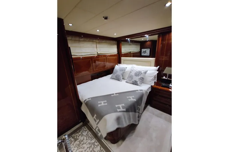 Slide: The Image of Luxurious bedroom interior of 2004 Mangusta 72 yacht with elegant wood paneling and cozy bedding. - 44