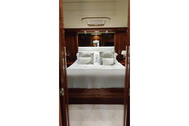 Slide: The Image of Luxurious bedroom interior of 2004 Mangusta 72 yacht with elegant bedding and wood finishes. - 53