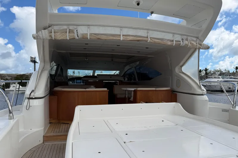 Slide: The Image of 2004 Mangusta 72 yacht with open deck and luxurious interior, docked at marina. - 6