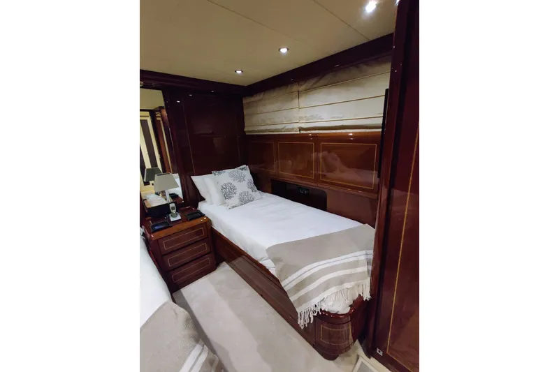 Slide: The Image of Luxurious cabin interior of 2004 Mangusta 72 yacht with elegant wood finish and cozy bedding. - 60