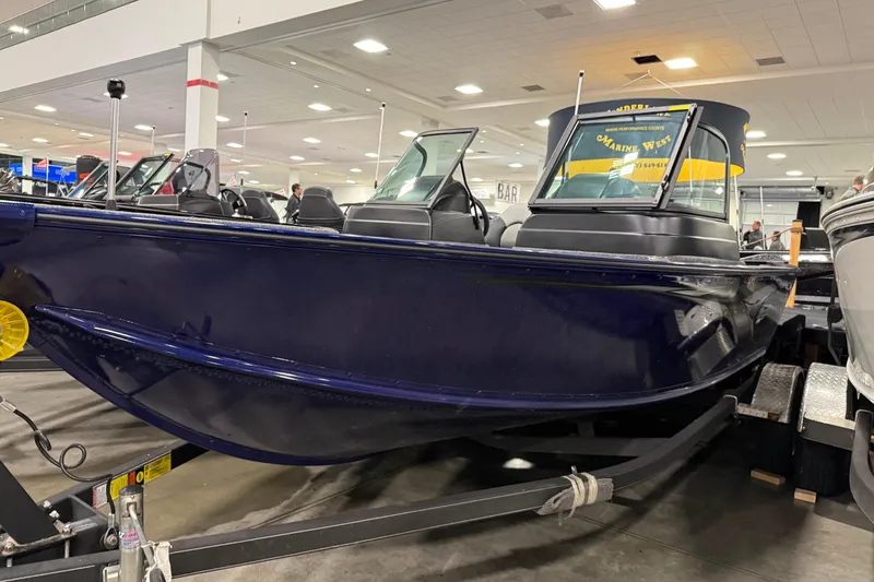 Slide: The Image of 2025 G3 Angler V178 F boat displayed indoors on a trailer. - 1