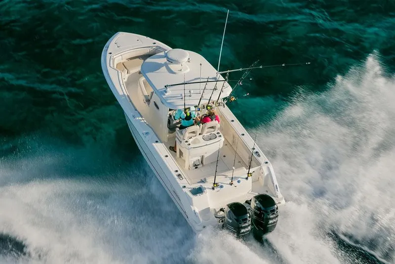 Slide: The Image of Manufacturer Provided Image: 2025 Boston Whaler 280 Outrage speeding on clear blue water. - 6