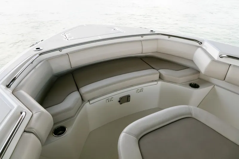 Slide: The Image of Manufacturer Provided Image: 2025 Boston Whaler 280 Outrage boat interior with cushioned seating and cup holders. - 8