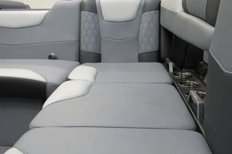 Slide: The Image of 2024 Malibu M220 interior seating with gray upholstery and cup holders. - 14