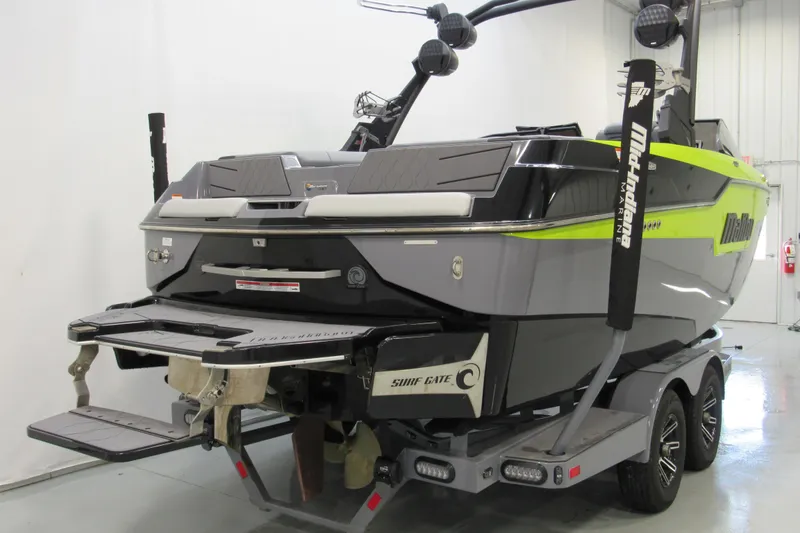 Slide: The Image of 2024 Malibu M220 boat on trailer, featuring sleek design and vibrant accents. - 2