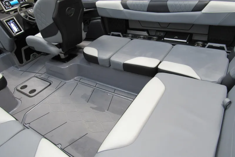 Slide: The Image of 2024 Malibu M220 boat interior with gray seating and modern dashboard. - 4