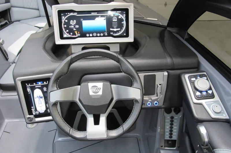 Slide: The Image of 2024 Malibu M220 boat dashboard with modern steering wheel and digital displays. - 8