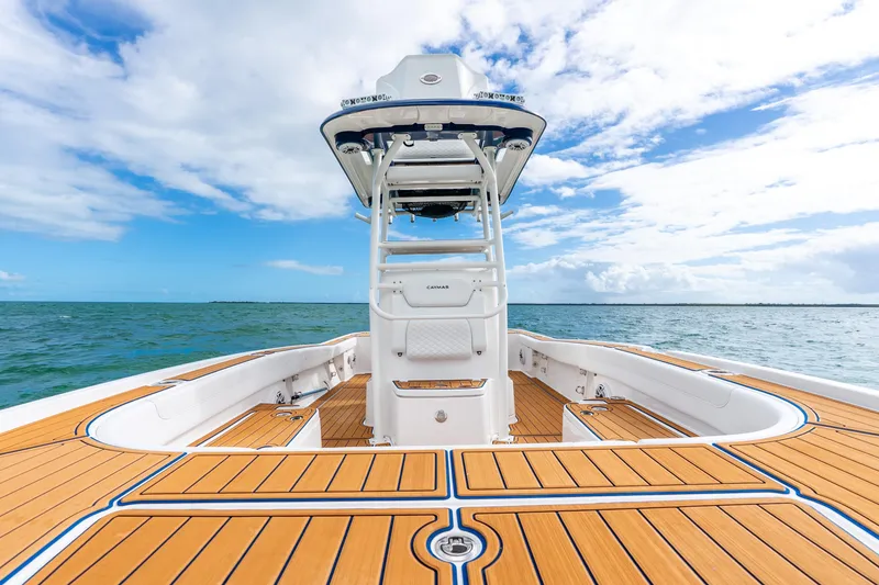 Slide: The Image of 2024 Caymas 281 HB boat on open water, featuring sleek deck design and clear skies. - 10