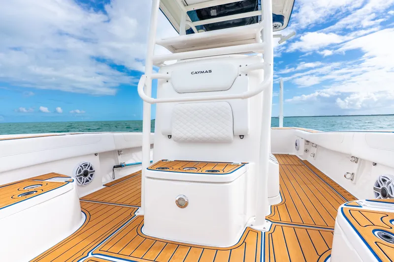 Slide: The Image of 2024 Caymas 281 HB boat interior with teak flooring, ocean view, and clear sky. - 11