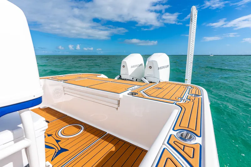 Slide: The Image of 2024 Caymas 281 HB boat with dual Mercury engines on turquoise water. - 14