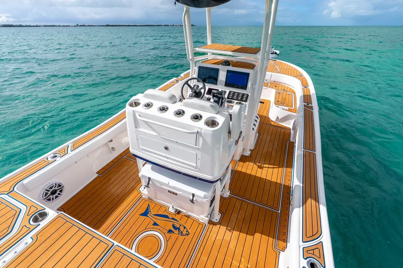 Slide: The Image of 2024 Caymas 281 HB boat with teak deck, navigating clear blue waters. - 18