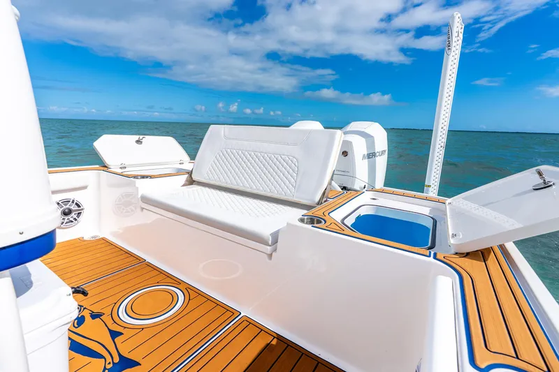Slide: The Image of 2024 Caymas 281 HB boat interior with seating, ocean view, and blue sky. - 19