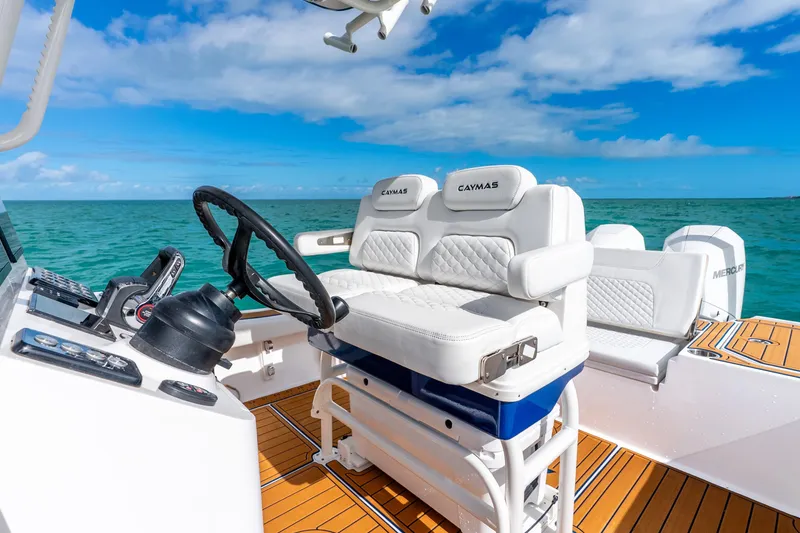 Slide: The Image of 2024 Caymas 281 HB boat interior with white seating and ocean view. - 23