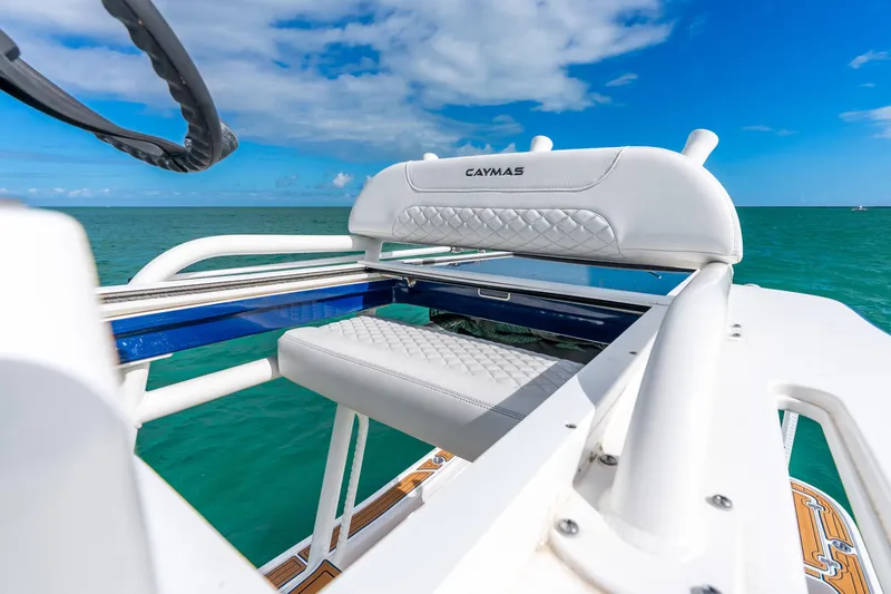 Slide: The Image of 2024 Caymas 281 HB boat with white seating, ocean view, and blue sky. - 27
