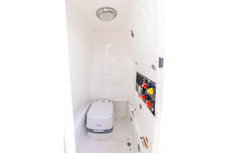 Slide: The Image of 2024 Caymas 281 HB boat interior with compact toilet and control panel. - 28