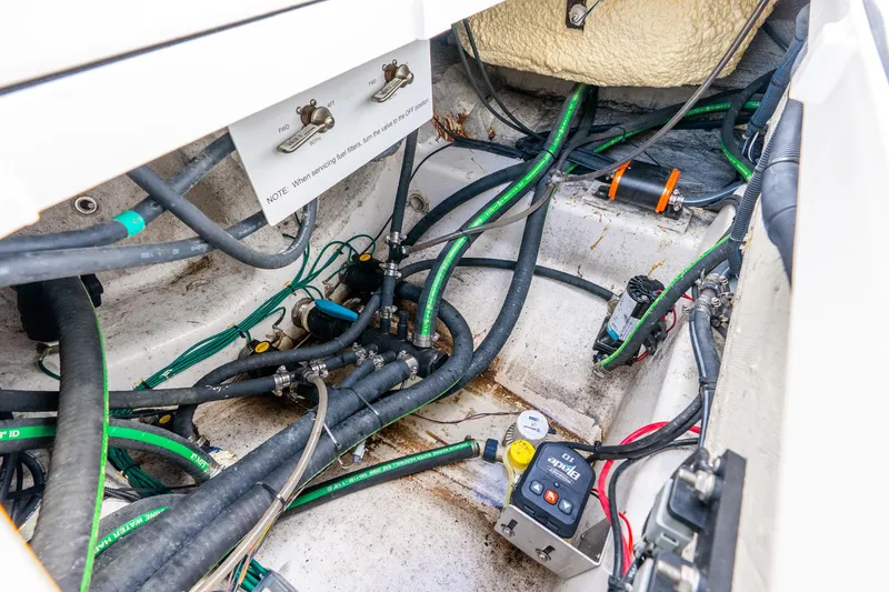 Slide: The Image of 2024 Caymas 281 HB boat engine compartment with wiring and fuel lines. - 31