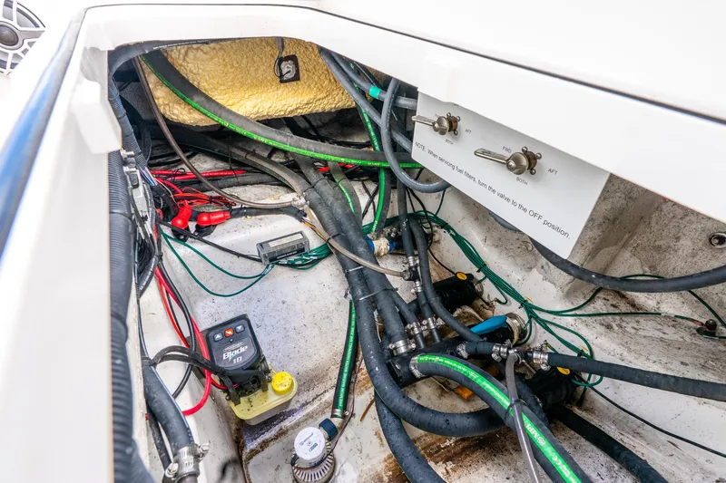Slide: The Image of 2024 Caymas 281 HB boat wiring and plumbing system in the engine compartment. - 32