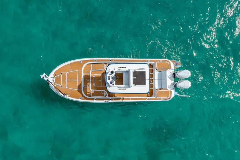Slide: The Image of Overhead view of 2024 Caymas 281 HB boat on turquoise water. - 4