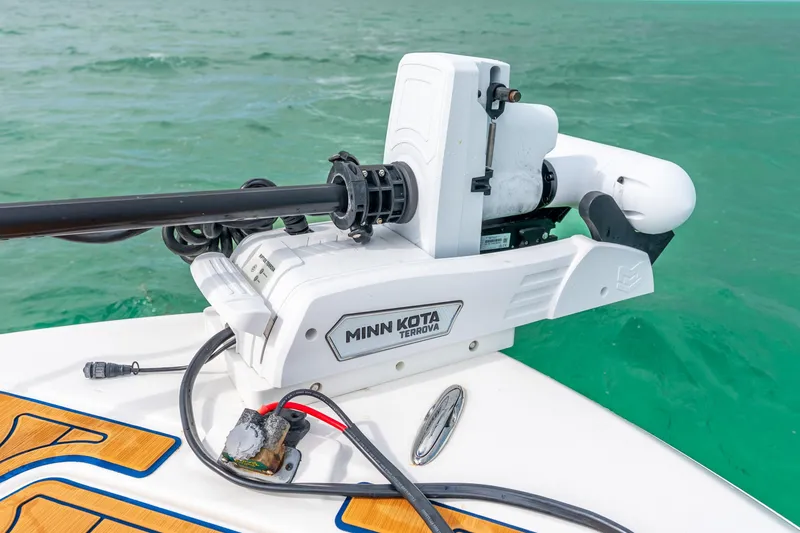 Slide: The Image of 2024 Caymas 281 HB with Minn Kota Terrova trolling motor on turquoise water. - 9