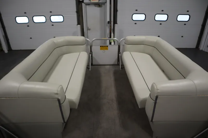 Slide: The Image of Interior of a 1994 San Pan 2500 pontoon boat with white seating. - 10