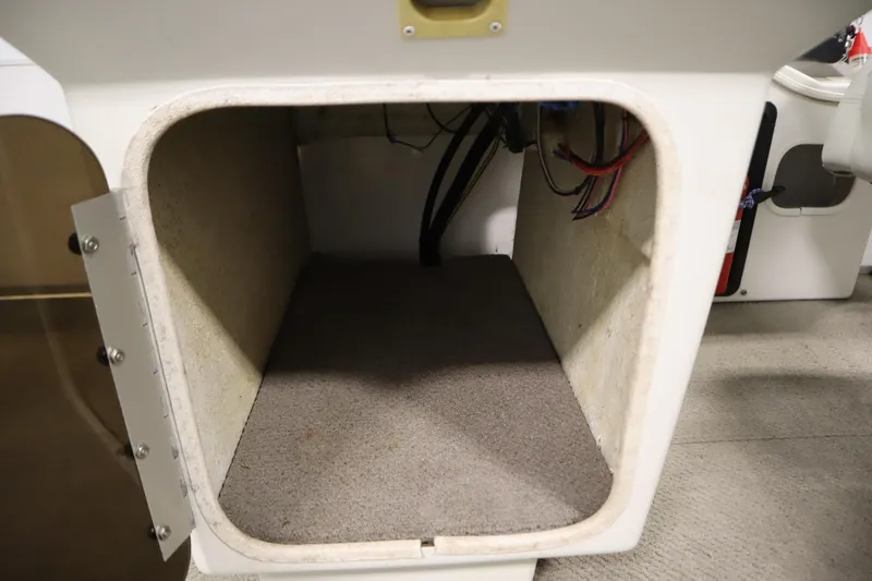 Slide: The Image of Open storage compartment in a 1994 San Pan 2500 boat, showing interior wiring. - 14