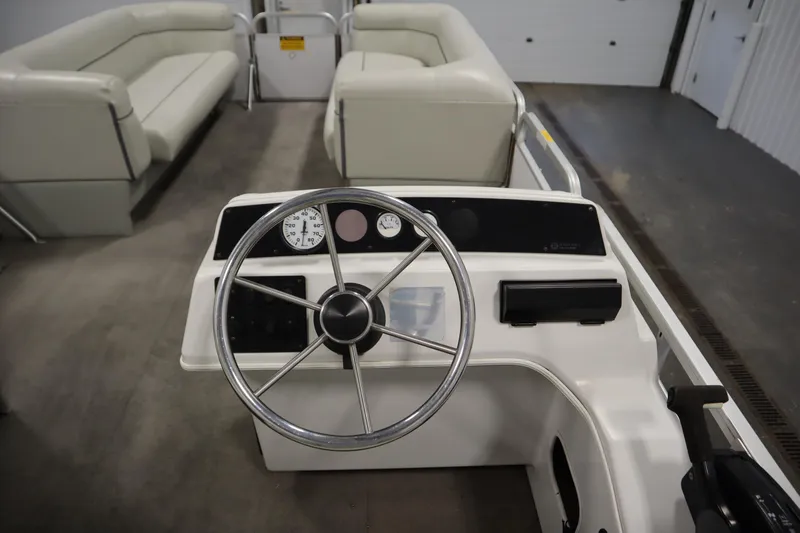 Slide: The Image of 1994 San Pan 2500 boat interior with steering wheel and seating. - 15