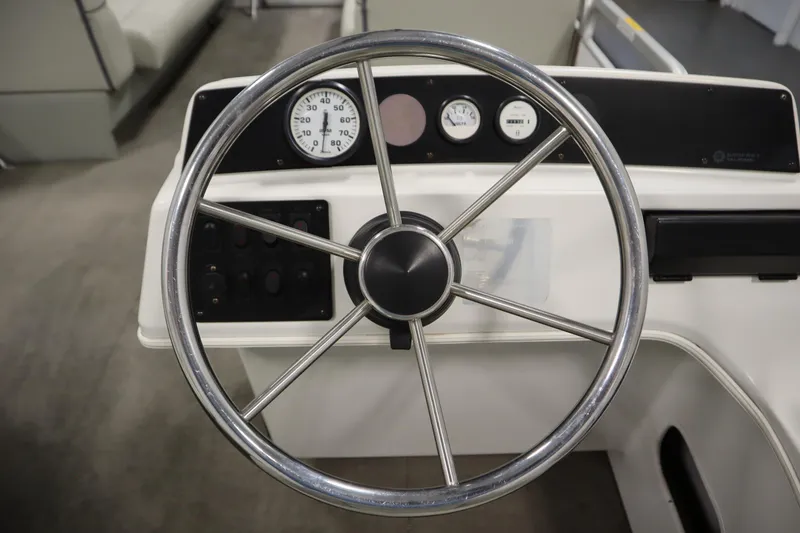 Slide: The Image of Steering wheel of a 1994 San Pan 2500 boat with gauges and controls. - 16